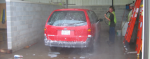 student washing a vehicle