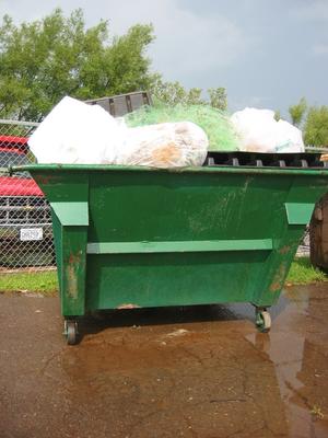 overfilled dumpster without a lid